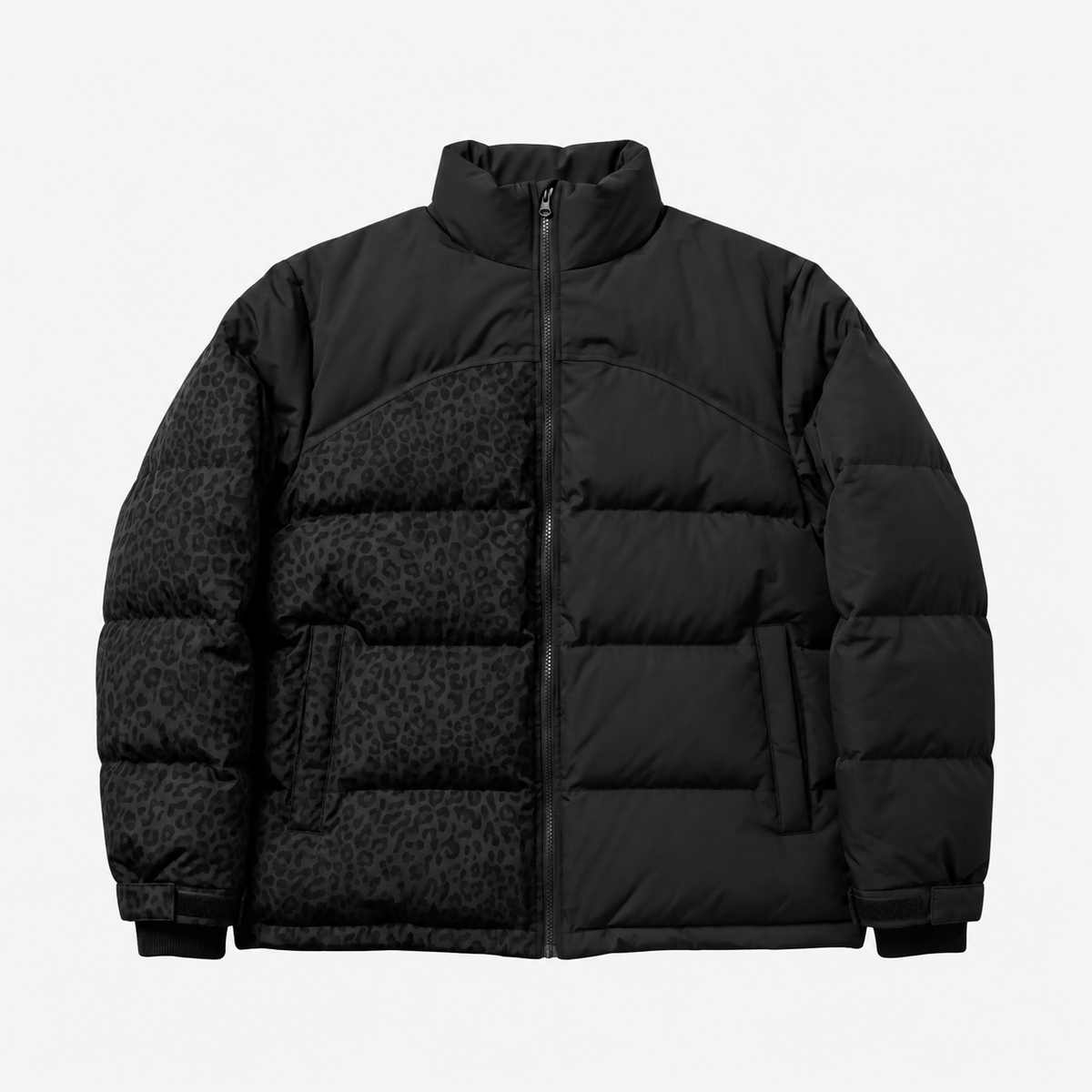 Black quilted puffer jacket with stand collar. The left half shows a tonal leopard pattern; the right half is solid black.